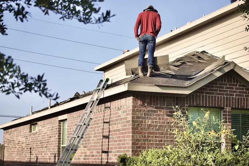 Professional roofer working on a residential roof in Gillsville